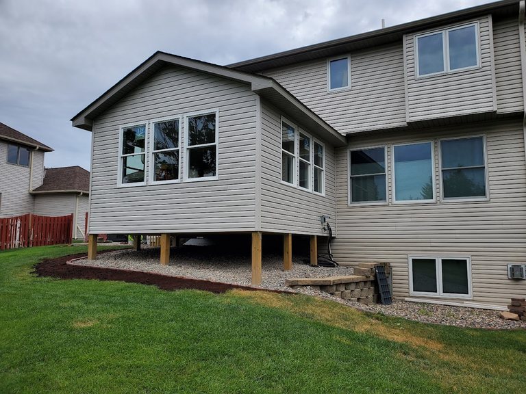 Two-story home addition with matching siding and windows — MDR Design-Build-Remodel