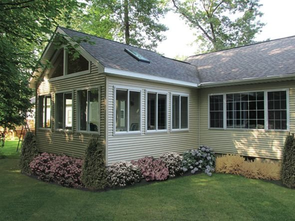 Exterior of a sunroom addition with fresh landscaping by MDR Design-Build-Remodel