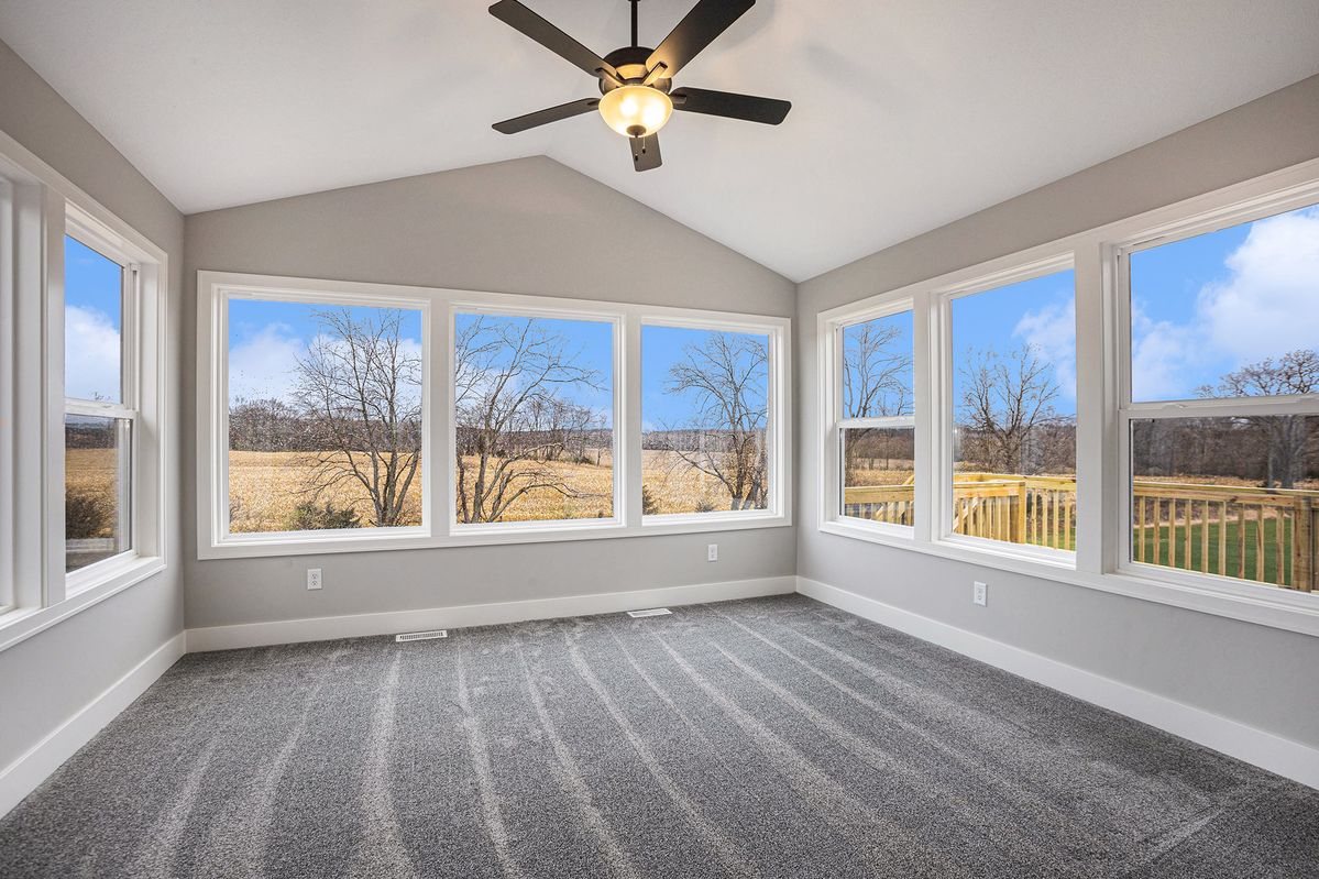 Vaulted sunroom addition with views of open fields by MDR Design-Build-Remodel