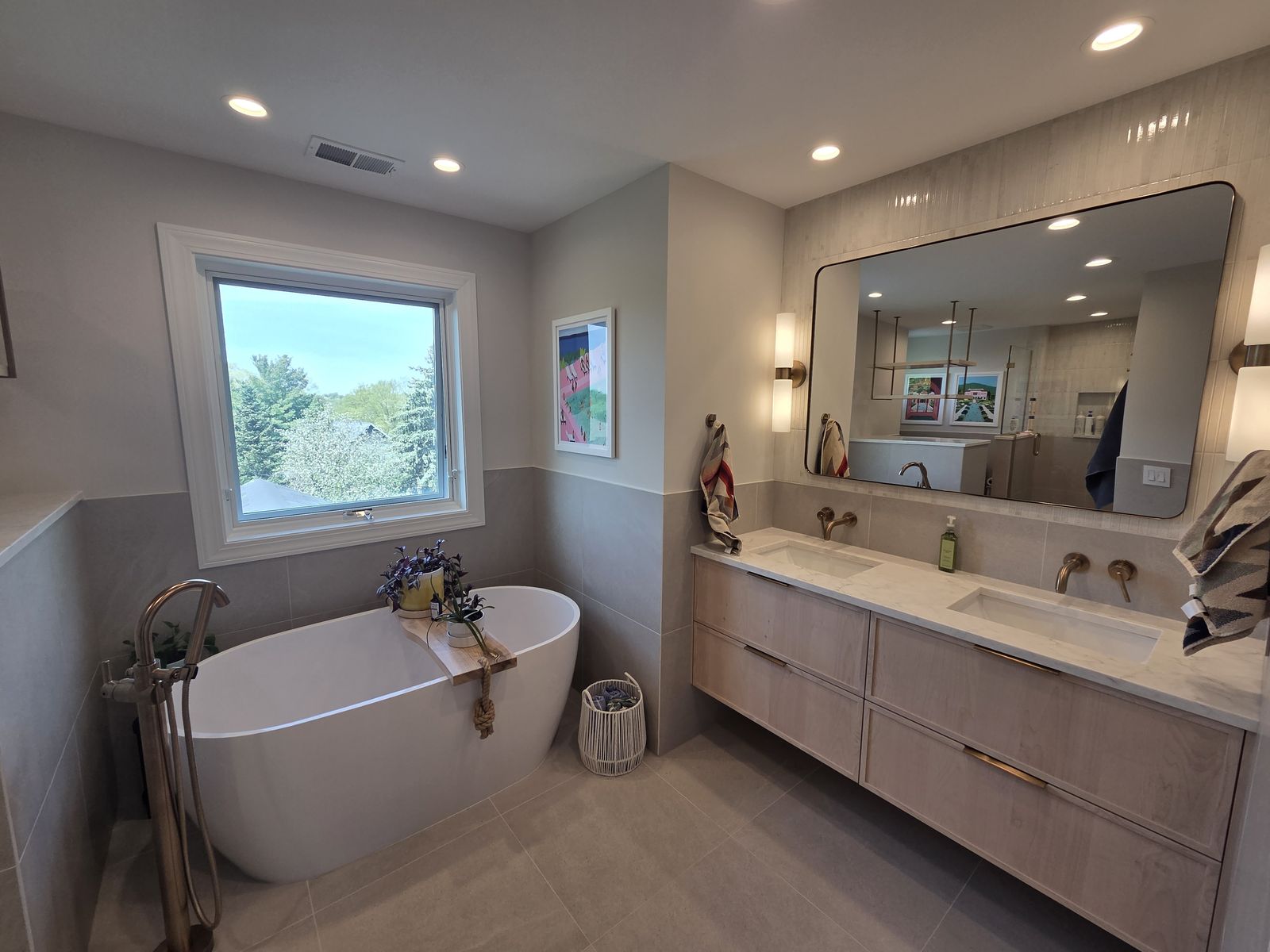 Bathroom remodel with a freestanding tub and a floating double vanity by MDR Design-Build-Remodel
